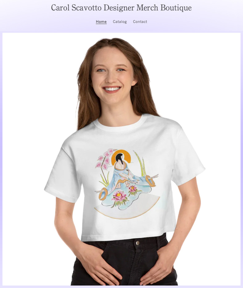 A brown haired white girl wears a cropped white T-shirt with a Carol Scavotto art image on it.